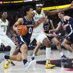 
              Virginia guard Kihei Clark (0) drives to the basket against Baylor forward Flo Thamba during the first half of an NCAA college basketball game Friday, Nov. 18, 2022, in Las Vegas. (AP Photo/Chase Stevens)
            