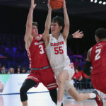 
              This photo provided by Bahamas Visual Services shows Dayton guard Mike Sharavjamts (55) driving against Wisconsin guard Connor Essegian (3) during an NCAA college basketball game at the Battle 4 Atlantis at Paradise Island, Bahamas, Wednesday, Nov. 23, 2022. . (Tim Aylen/Bahamas Visual Services via AP)
            