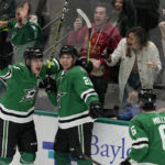 
              Dallas Stars' Roope Hintz (24), Jason Robertson (21) and Colin Miller (6) celebrate after Robertson scored late in the third period of an NHL hockey game against the Colorado Avalanche Monday, Nov. 21, 2022, in Dallas. (AP Photo/Tony Gutierrez)
            