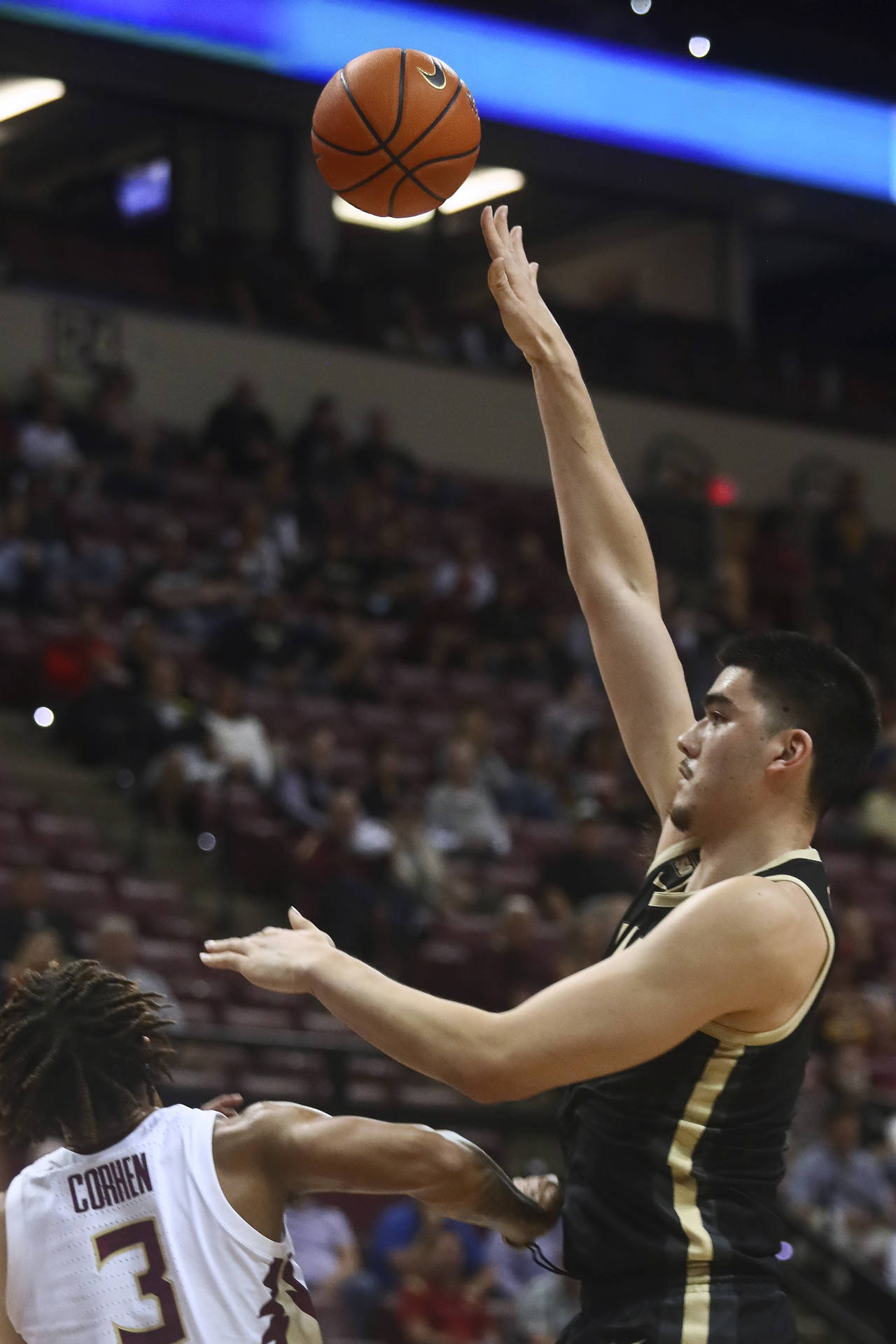 Purdue center Zach Edey (15) shoots over Florida State forward Cameron Corhen (3) during the first ...