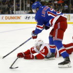 
              New York Rangers left wing Alexis Lafreniere, top, and Detroit Red Wings left wing Adam Erne battle for the puck during the first period of an NHL hockey game Sunday, Nov. 6, 2022, in New York. (AP Photo/John Munson)
            