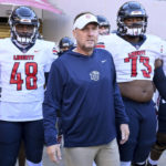 
              Liberty head coach Hugh Freeze, center, gets ready to take the field with his team to play Arkansas in an NCAA college football game Saturday, Nov. 5, 2022, in Fayetteville, Ark. (AP Photo/Michael Woods)
            