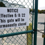 
              A sign is affixed to a gate at the shuttered Arlington International Racecourse in Arlington Heights, Ill., Friday, Oct. 14, 2022. The Bears want to turn the Arlington Heights site, once a jewel of thoroughbred racing, into a different kind of gem, anchored by an enclosed stadium and bursting with year-round activity — assuming a deal with Churchill Downs Inc. to buy the land goes through. (AP Photo/Nam Y. Huh)
            