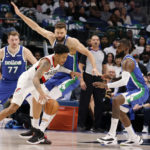 
              Portland Trail Blazers guard Anfernee Simons is defended by Dallas Mavericks guard Luka Doncic, forward Maxi Kleber (42) and forward Tim Hardaway Jr., right, during the first half of an NBA basketball game in Dallas, Saturday, Nov. 12, 2022. (AP Photo/Michael Ainsworth)
            
