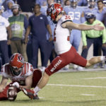 
              North Carolina State's Christopher Dunn (32) hits a field goal against North Carolina from the hold of Shane McDonough (97) during the second overtime in an NCAA college football game Friday, Nov. 25, 2022, in Chapel Hill, N.C. (AP Photo/Chris Seward)
            