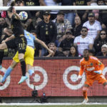 
              Los Angeles FC forward Gareth Bale, left, scores the equalizing goal past Philadelphia Union defender Jack Elliott (3) and goalkeeper Andre Blake during overtime in the MLS Cup soccer match Saturday, Nov. 5, 2022, in Los Angeles. (AP Photo/Marcio Jose Sanchez)
            