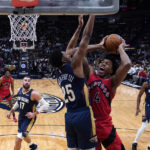 
              Toronto Raptors forward Scottie Barnes (4) goes to the basket against New Orleans Pelicans guard Trey Murphy III (25) in the first half of an NBA basketball game in New Orleans, Wednesday, Nov. 30, 2022. (AP Photo/Gerald Herbert)
            