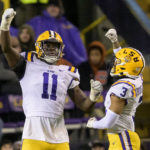 
              LSU defensive end Ali Gaye (11) celebrates a sack of UAB quarterback Dylan Hopkins with safety Greg Brooks Jr. (3) during the first half of an NCAA college football game in Baton Rouge, La., Saturday, Nov. 19, 2022. (AP Photo/Matthew Hinton)
            
