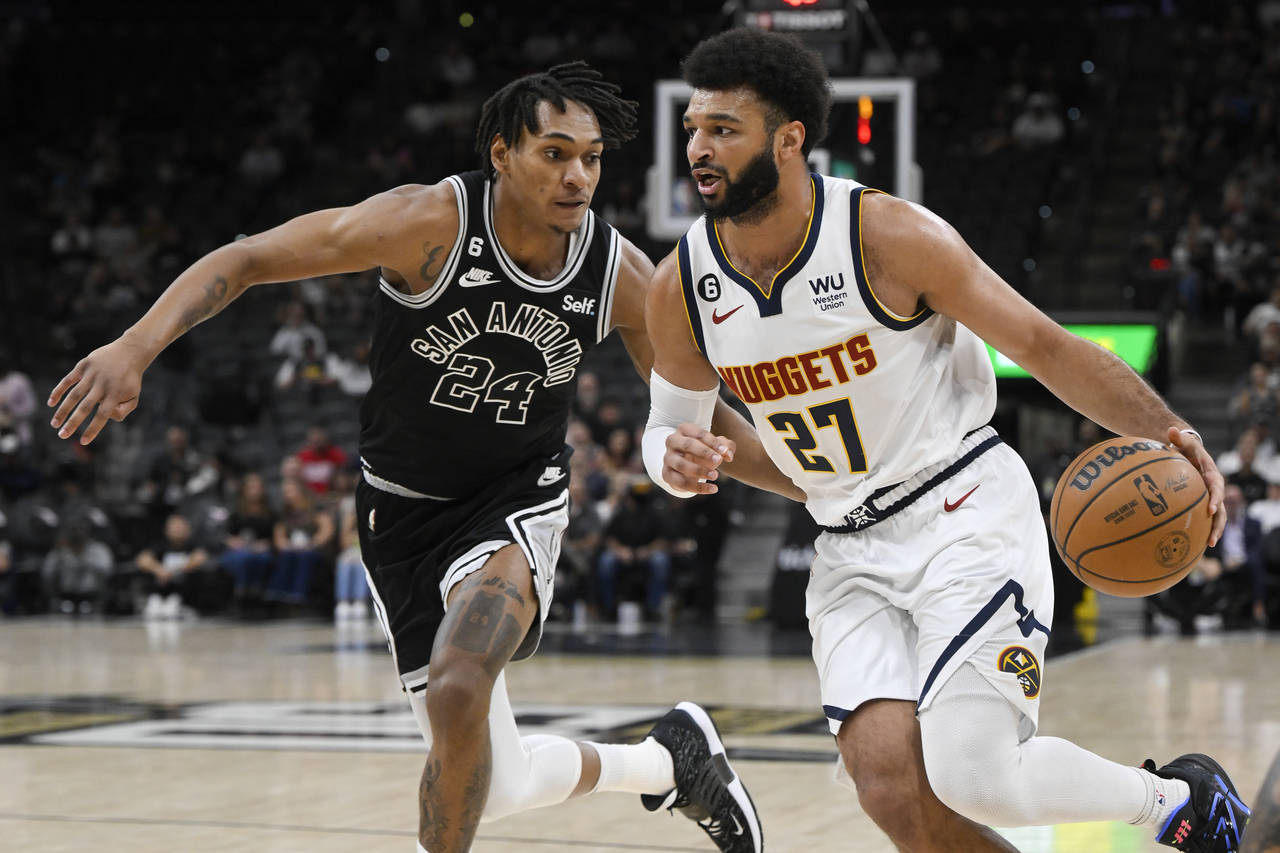 Denver Nuggets' Jamal Murray (27) drives against San Antonio Spurs' Devin Vassell during the first ...