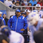 
              BYU head coach Kalani Sitake, center, looks on from the sideline before the snap against Boise State in the first half of an NCAA college football game, Saturday, Nov. 5, 2022, in Boise, Idaho. (AP Photo/Steve Conner)
            