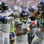 
              Seattle Seahawks running back Kenneth Walker III, middle, is congratulated by tight end Noah Fant, left, and tight end Colby Parkinson (84) after scoring against the Arizona Cardinals during the second half of an NFL football game in Glendale, Ariz., Sunday, Nov. 6, 2022. (AP Photo/Matt York)
            