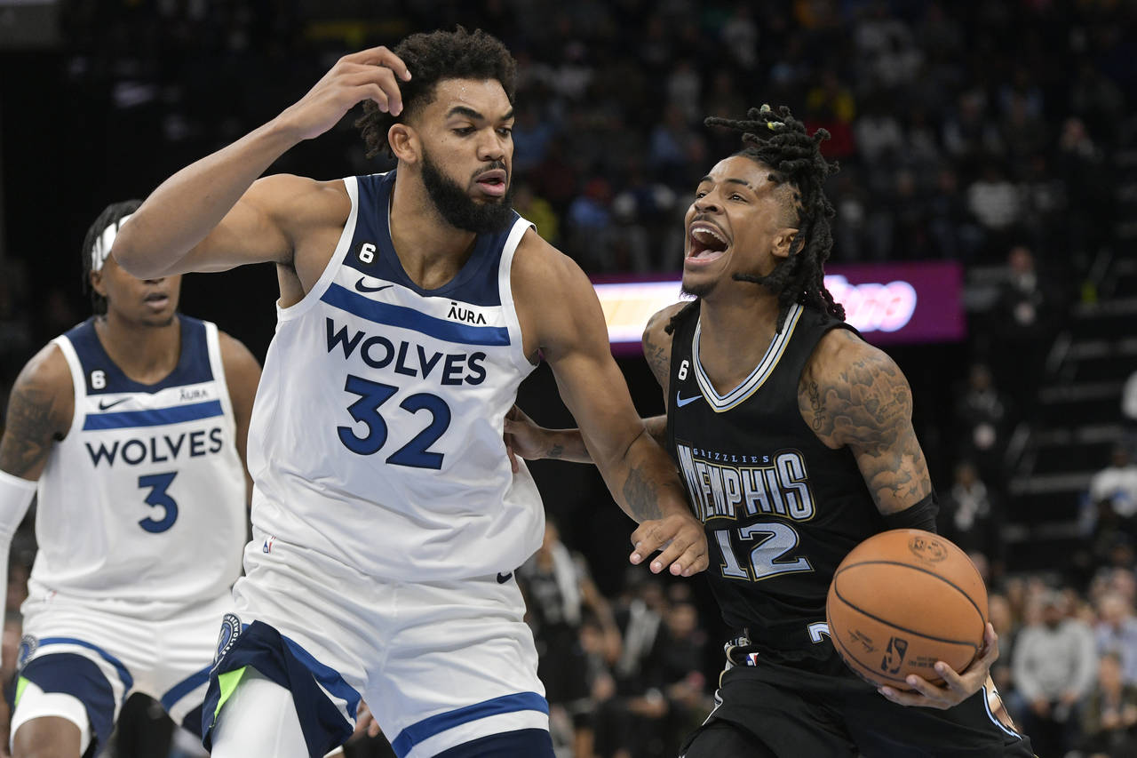 Memphis Grizzlies guard Ja Morant (12) drives against Minnesota Timberwolves center Karl-Anthony To...