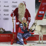 
              United States' Mikaela Shiffrin poses with Santa Claus and a reindeer after winning an alpine ski, women's World Cup slalom, in Levi, Finland, Sunday, Nov. 20, 2022. (AP Photo/Alessandro Trovati)
            