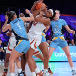 
              In a photo provided by Bahamas Visual Services, Texas' Aaliyah Moore (23) tries to get possession of the ball next to Marquette's Nia Clark during an NCAA college basketball game at the Battle 4 Atlantis on Saturday, Nov. 19, 2022, at Paradise Island, Bahamas. (Tim Aylen/Bahamas Visual Services via AP)
            