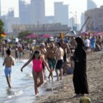 
              Beachgoers enjoy the day in Doha, Qatar, Thursday, Nov. 24, 2022. (AP Photo/Jorge Saenz)
            