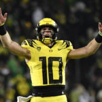 
              Oregon quarterback Bo Nix (10) celebrates a touchdown against Washington during the second half of an NCAA college football game Saturday, Nov. 12, 2022, in Eugene, Ore. (AP Photo/Andy Nelson)
            