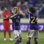 
              Japan's Yuki Soma and Takuma Asanocelebrate after a goal during a friendly soccer match between Canada and Japan in Dubai, Thursday, Nov. 17, 2022. (AP Photo/Christopher Pike)
            