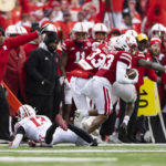 
              Nebraska's Malcolm Hartzog, right, returns an interception for 23 yards past Wisconsin's Chimere Dike, left, during the first half of an NCAA college football game Saturday, Nov. 19, 2022, in Lincoln, Neb. (AP Photo/Rebecca S. Gratz)
            