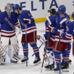 
              New York Rangers goalie Igor Shesterkin, left, is congratulated by teammates led by defenseman Braden Schneider (4) after they defeated the Arizona Coyotes in an NHL hockey game Sunday, Nov. 13, 2022, in New York. (AP Photo/John Munson)
            