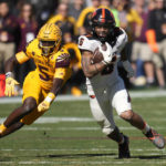 
              Oregon State running back Damien Martinez (6) runs past Arizona State defensive back Chris Edmonds (5) during the first half of an NCAA college football game in Tempe, Ariz., Saturday, Nov. 19, 2022. (AP Photo/Ross D. Franklin)
            