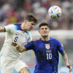 
              England's John Stones vies for the ball with Christian Pulisic of the United States, right, during the World Cup group B soccer match between England and The United States, at the Al Bayt Stadium in Al Khor , Qatar, Friday, Nov. 25, 2022. (AP Photo/Luca Bruno)
            