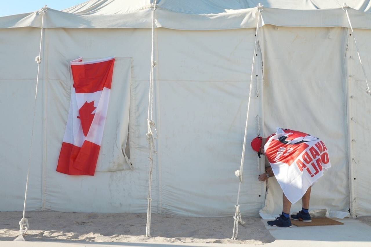 Canadian Modar Safar of Gilbert, Ontario ties closed his tent at a site in Al Khor, Qatar, Wednesda...