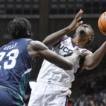 
              UNC Wilmington forward Amari Kelly (23) fouls Connecticut's Nahiem Alleyne during the first half of an NCAA college basketball game Friday, Nov. 18, 2022, in Storrs, Conn. (AP Photo/Jessica Hill)
            