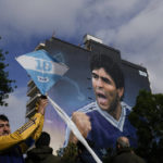 
              A man holds a kite during the inauguration of the mural of Diego Maradona by artist Martin Ron in Buenos Aires, Argentina, Sunday, Oct. 30, 2022. Sunday marks the birth date of Maradona who died on Nov. 25, 2020 at the age of 60.(AP Photo/Rodrigo Abd)
            