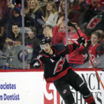 
              Carolina Hurricanes center Sebastian Aho (20) and Hurricanes fans celebrate after he scored his third goal of the night, during the third period of the team's NHL hockey game against the Buffalo Sabres on Friday, Nov. 4, 2022, in Raleigh, N.C. (AP Photo/Chris Seward)
            
