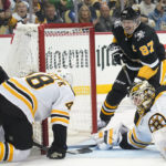 
              Pittsburgh Penguins' Bryan Rust (17) pushes the puck into the net past Boston Bruins goaltender Linus Ullmark (35) for a goal during the second period of an NHL hockey game Tuesday, Nov. 1, 2022, in Pittsburgh. (AP Photo/Keith Srakocic)
            