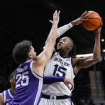 
              Butler center Manny Bates (15) shoots over Kansas State forward Ismael Massoud (25) in the first half of an NCAA college basketball game in Indianapolis, Wednesday, Nov. 30, 2022. (AP Photo/Michael Conroy)
            