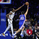 
              Philadelphia 76ers' Georges Niang, right, goes up for a shot against Brooklyn Nets' Kevin Durant during the second half of an NBA basketball game, Tuesday, Nov. 22, 2022, in Philadelphia. (AP Photo/Matt Slocum)
            