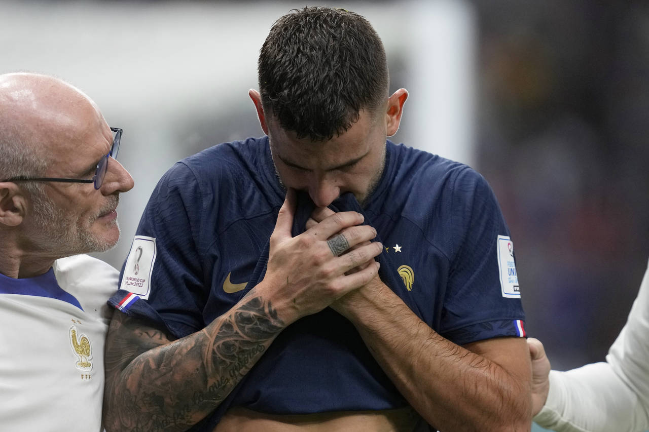 France's Lucas Hernandez leaves the pitch after getting injured during the World Cup group D soccer...