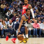 
              Denver Nuggets guard Ish Smith (14) drives to the basket against Houston Rockets forward Kenyon Martin Jr. (6) during the fourth quarter of an NBA basketball game, Monday, Nov. 28, 2022, in Denver. (AP Photo/Jack Dempsey)
            