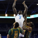 
              UCLA forward Adem Bona, center, shoots as Norfolk State forward Dana Tate Jr., left, and forward Kris Bankston defend during the first half of an NCAA college basketball game Monday, Nov. 14, 2022, in Los Angeles. (AP Photo/Mark J. Terrill)
            