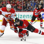 
              New Jersey Devils defenseman Brendan Smith (2) plays the puck against Calgary Flames center Mikael Backlund (11) during the second period of an NHL hockey game, Tuesday, Nov. 8, 2022, in Newark, N.J. (AP Photo/Noah K. Murray)
            