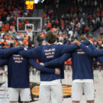 
              Virginia players wear shirts in honor of football players Devin Chandler, D'Sean Perry and Lavel Davis Jr. before an NCAA college basketball game against Illinois, Sunday, Nov. 20, 2022, in Las Vegas. The three (AP Photo/John Locher)
            