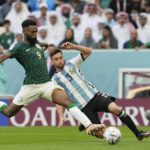 
              Saudi Arabia's Firas Al-Buraikan, left, fights for the ball with Argentina's Nicolas Tagliafico during the World Cup group C soccer match between Argentina and Saudi Arabia at the Lusail Stadium in Lusail, Qatar, Tuesday, Nov. 22, 2022. (AP Photo/Ebrahim Noroozi)
            