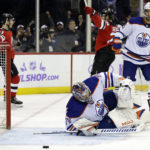 
              Edmonton Oilers goaltender Stuart Skinner, front, reacts after giving up a goal to New Jersey Devils defenseman Damon Severson during the second period of an NHL hockey game Monday, Nov. 21, 2022, in Newark, N.J. (AP Photo/Adam Hunger)
            