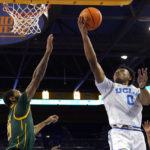 
              UCLA guard Jaylen Clark, right, shoots as Norfolk State forward Dana Tate Jr. defends during the first half of an NCAA college basketball game Monday, Nov. 14, 2022, in Los Angeles. (AP Photo/Mark J. Terrill)
            