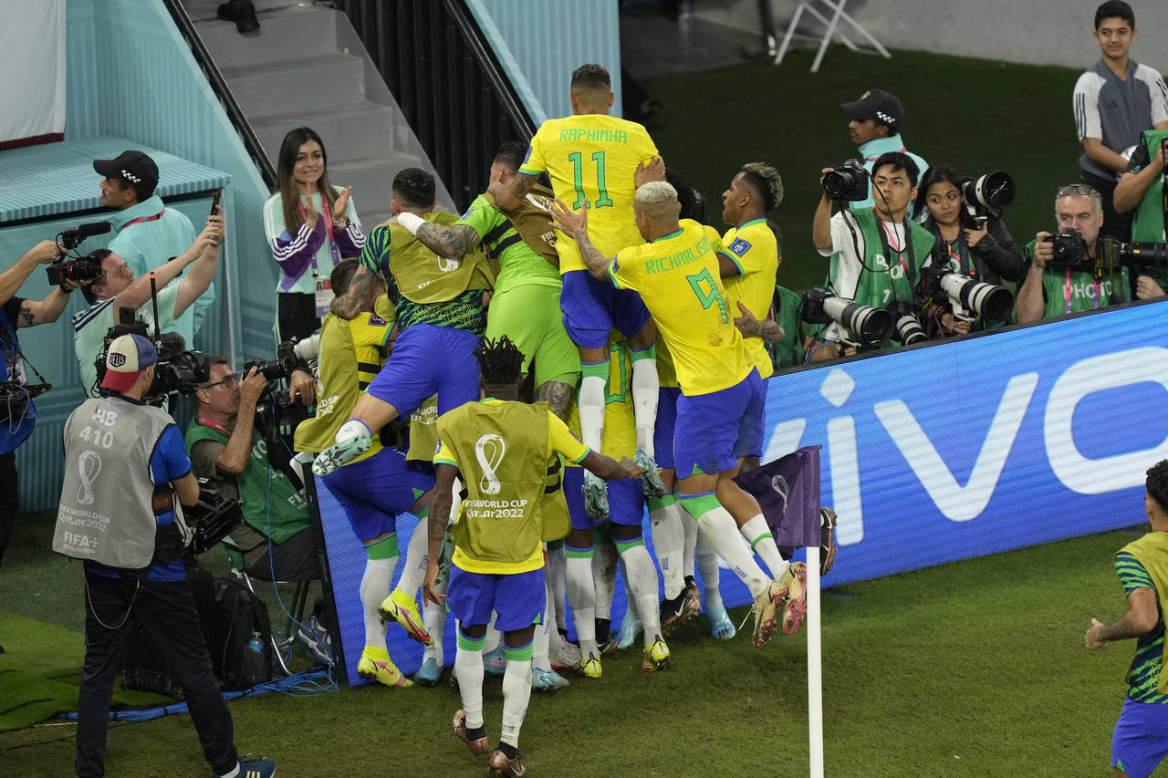 Brazil's Casemiro celebrates with teammates after scoring his side's first goal during the World Cu...