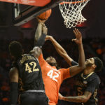 
              Illinois' Dain Dainja (42) lays the ball up as Lindenwood's Remy Lemovou (42) and Cam Burrell (5) defend during the first half of an NCAA college basketball game, Friday, Nov. 25, 2022, in Champaign, Ill. (AP Photo/Michael Allio)
            