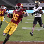 
              Southern California wide receiver Tahj Washington celebrates his touchdown, as Colorado safety Tyrin Taylor trails during the second half of an NCAA college football game Friday, Nov. 11, 2022, in Los Angeles. (AP Photo/John McCoy)
            