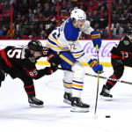 
              Ottawa Senators defenseman Jake Sanderson (85) gets his stick under the knee of Buffalo Sabres right wing Tage Thompson (72) as he winds up for a shot during the first period of an NHL hockey game, Wednesday, Nov. 16, 2022 in Ottawa, Ontario. (Justin Tang/The Canadian Press via PA)
            