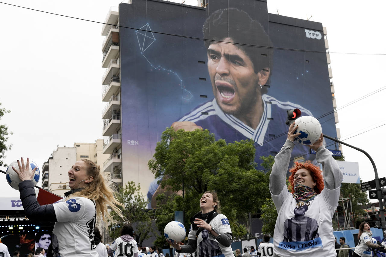 Women play with balls during the inauguration of a mural of Diego Maradona by artist Martin Ron in ...
