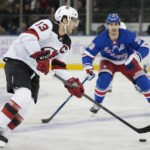 
              New Jersey Devils center Nico Hischier (13) looks to pass against New York Rangers left wing Chris Kreider (20) in the second period of an NHL hockey game, Monday, Nov. 28, 2022, in New York. (AP Photo/John Minchillo)
            
