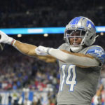 
              Detroit Lions wide receiver Amon-Ra St. Brown reacts after his 1-yard reception for a touchdown during the first half of an NFL football game against the Buffalo Bills, Thursday, Nov. 24, 2022, in Detroit. (AP Photo/Paul Sancya)
            