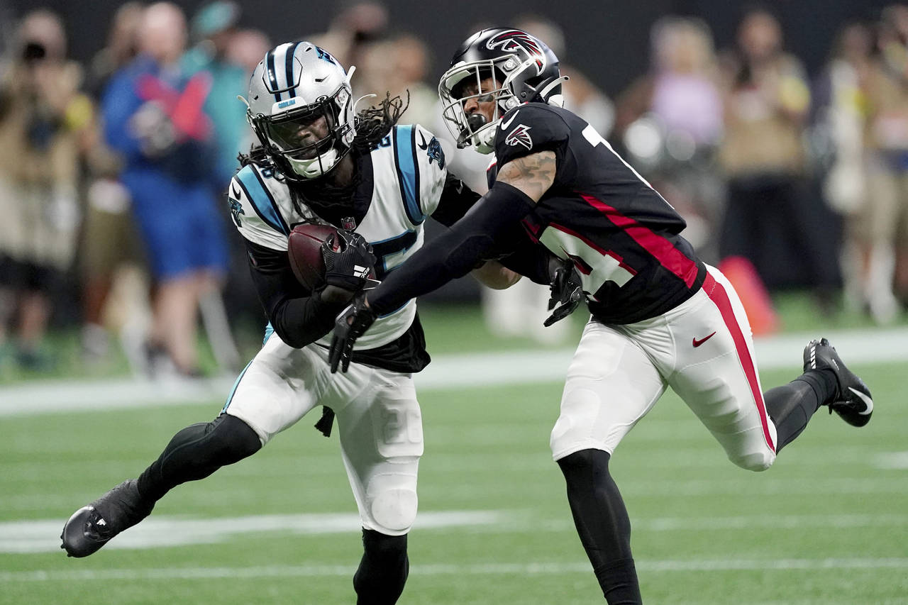 Carolina Panthers cornerback Donte Jackson, left, intercepts a pass intended for Atlanta Falcons wi...