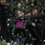 
              Frankfurt staff members celebrate after they beat Sporting to quality for the next round after a Champions League group D soccer match between Sporting CP and Frankfurt at the Alvalade stadium in Lisbon, Tuesday, Nov. 1, 2022. (AP Photo/Armando Franca)
            