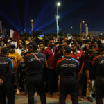 
              Policemen stand in line to limit the number of fans entering the fan zone to watch the World Cup, group A soccer match between Qatar and Ecuador in Doha, Sunday, Nov. 20, 2022. (AP Photo/Petr David Josek)
            